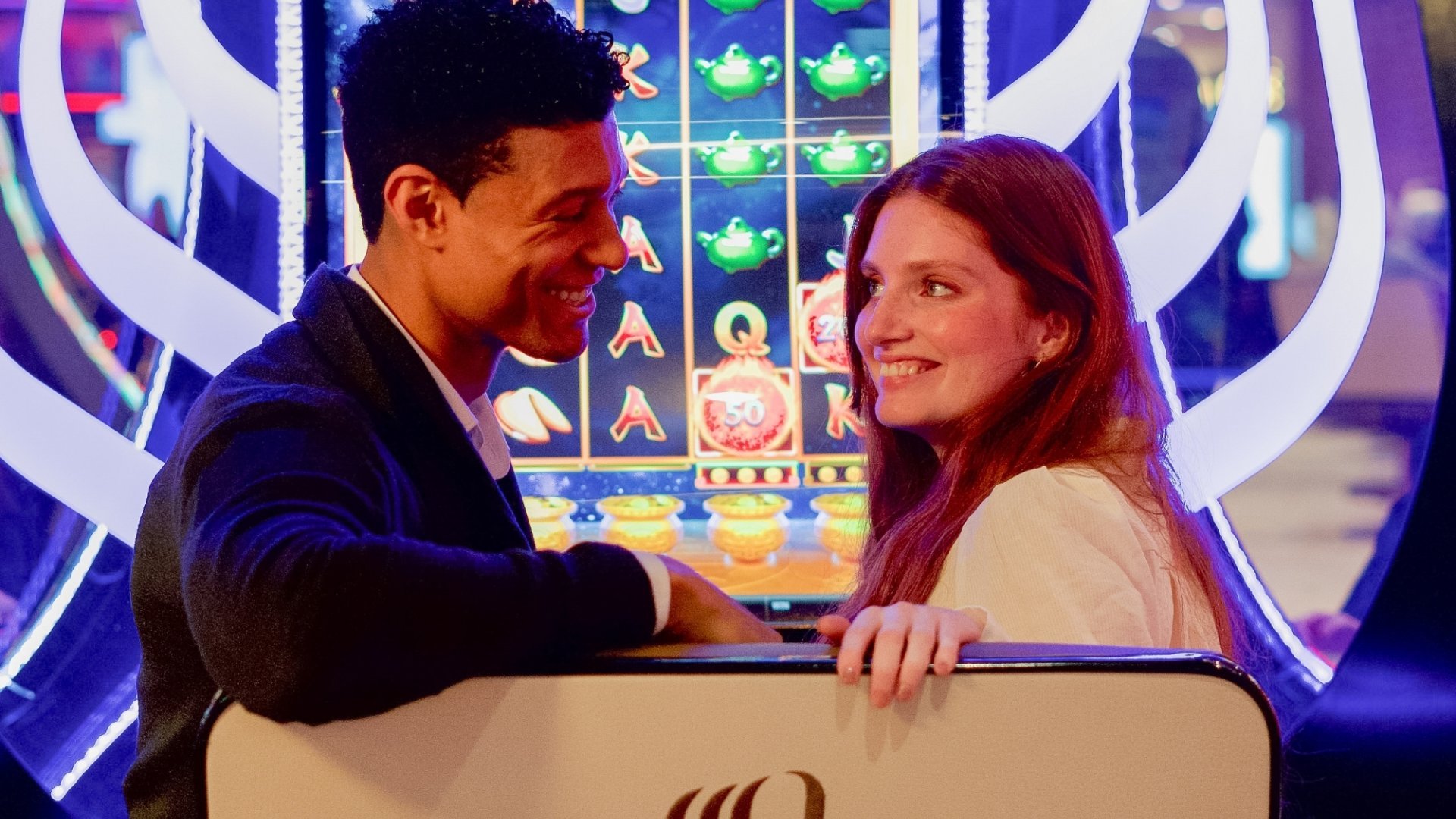 Deux amis profitent d'une session de jeux aux machines à sous du Casino Partouche de Pornichet, créant des moments de divertissement et de plaisir.